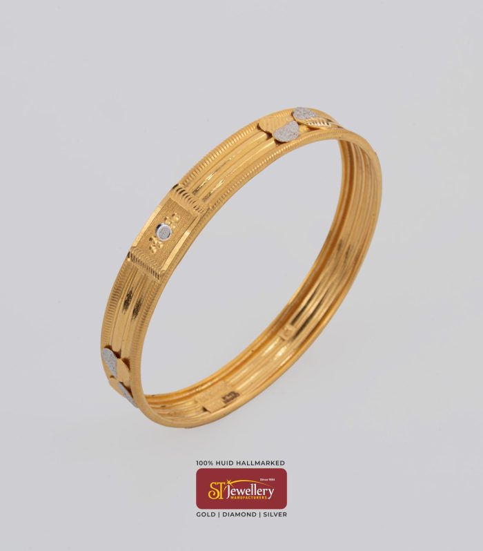 Elegant gold bangle with textured lines and heart motif – premium lightweight gold jewellery by ST Jewellery Manufacturers Thrissur Kerala