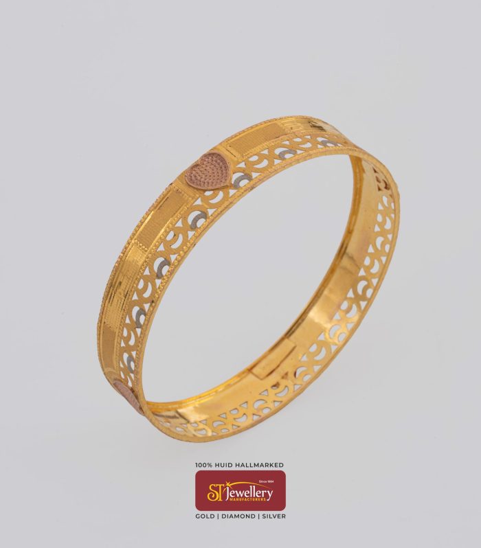 Elegant gold bangle with heart motif and intricate cutwork design – premium gold jewellery by ST Jewellery Manufacturers Thrissur Kerala