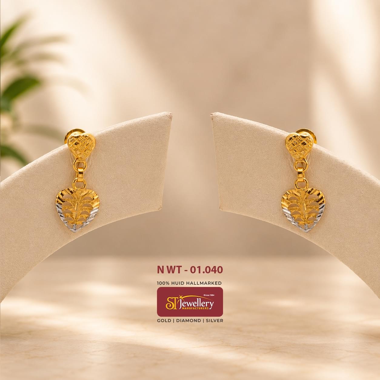 Lightweight heart-shaped gold drop earrings with elegant leaf-pattern detailing and dual-tone accents, perfect for daily wear and modern styling.
