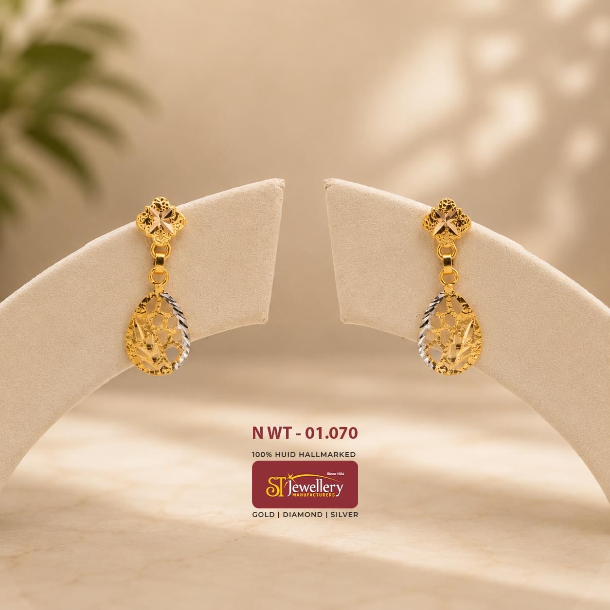 Lightweight teardrop gold earrings with intricate cutwork detailing and dual-tone finish, perfect for daily wear and elegant occasions.