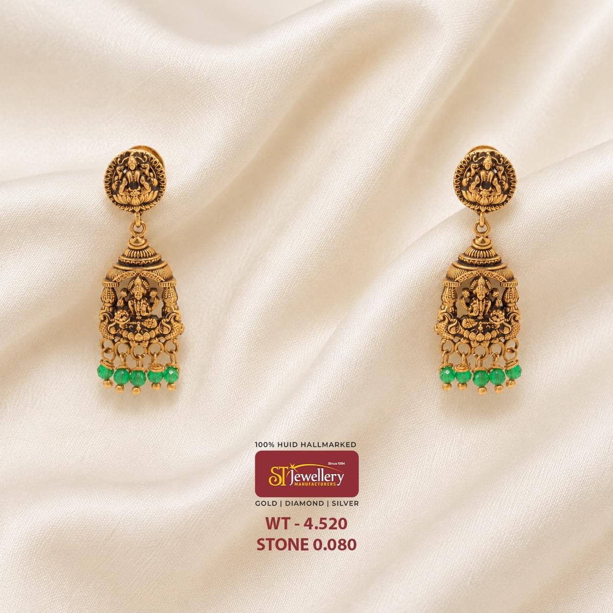 “Traditional antique Lakshmi temple gold earrings with intricate deity carvings and elegant green bead drops, perfect for bridal and festive wear.”