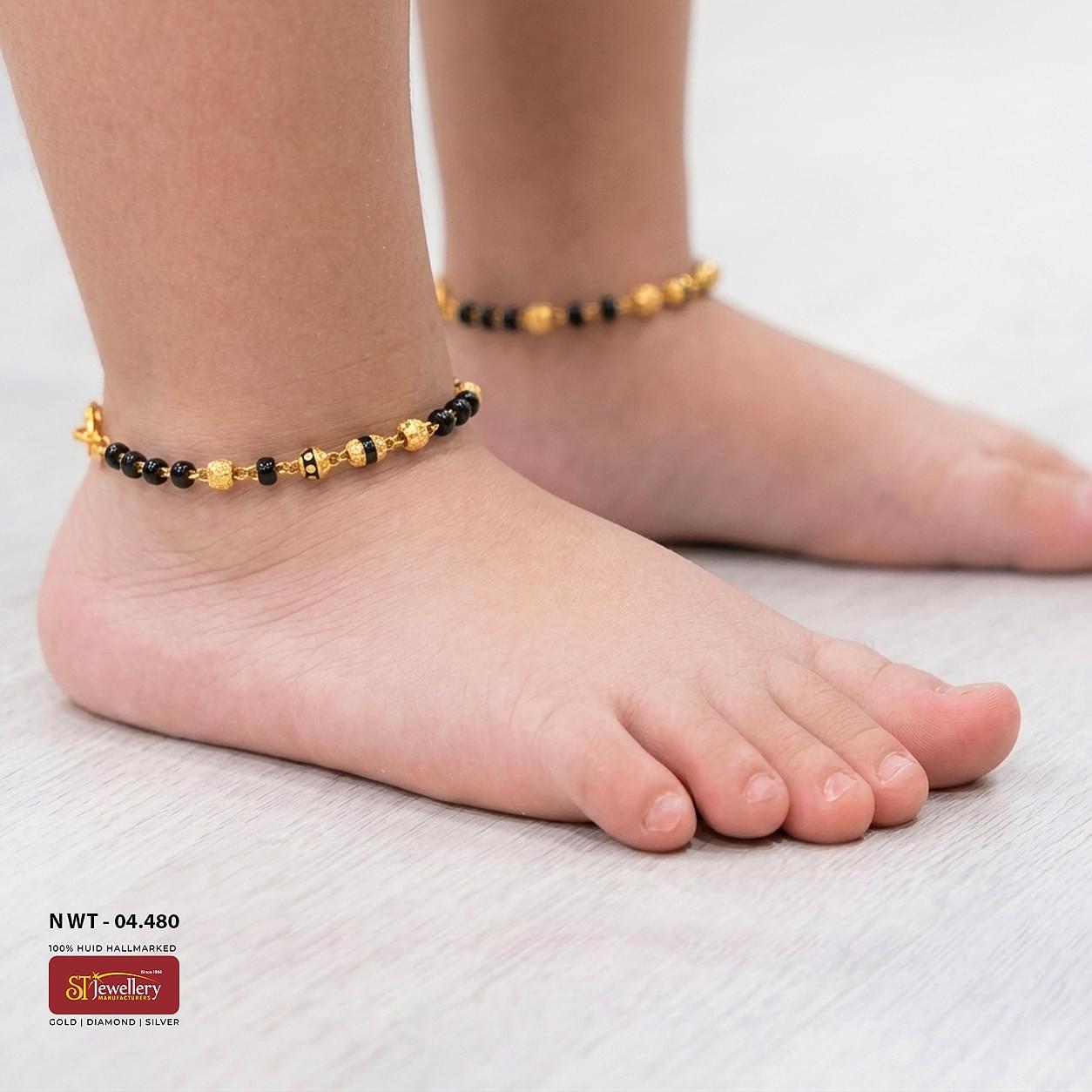Traditional gold and black bead anklet for kids featuring decorative gold beads and elegant handcrafted detailing.