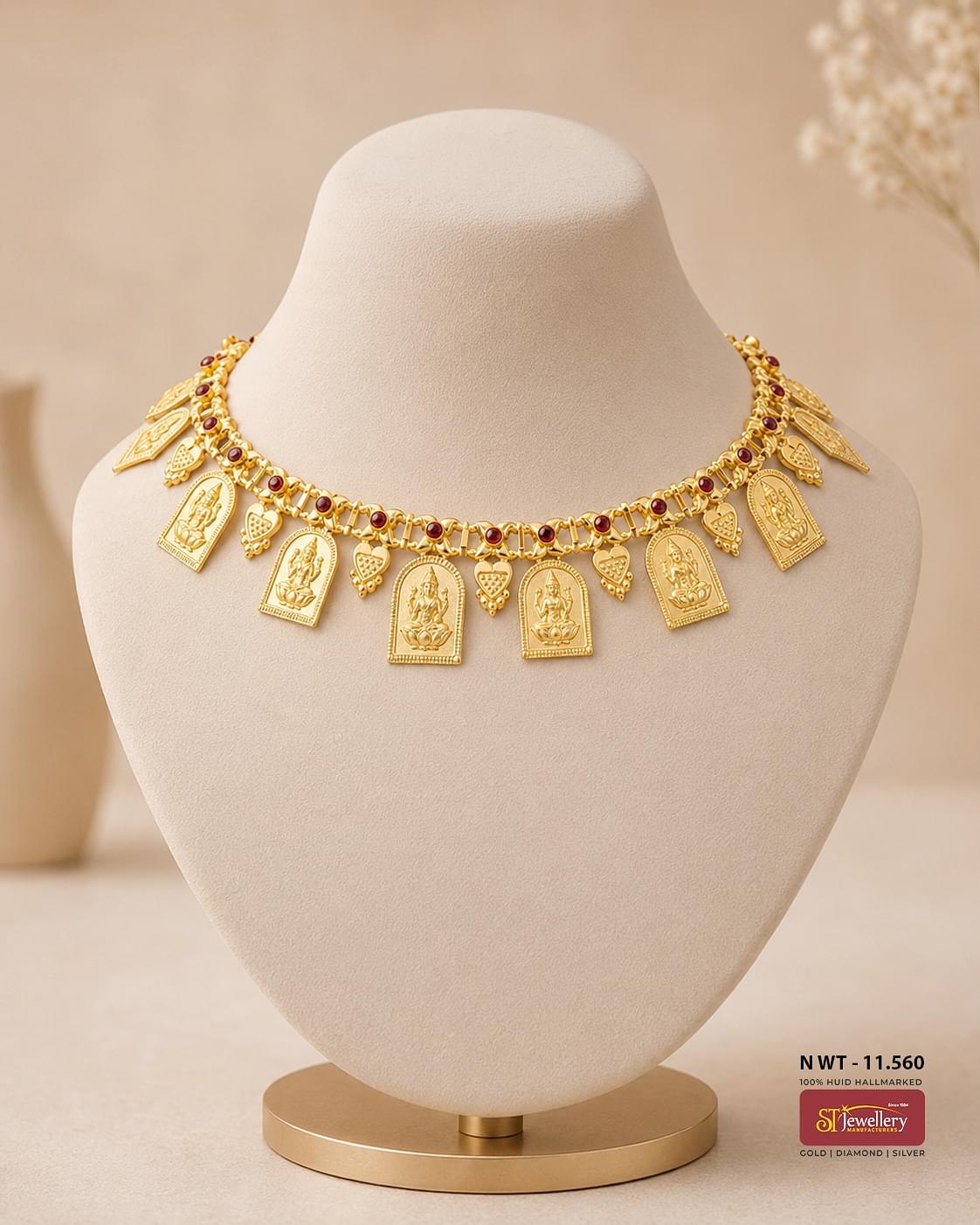 Traditional Lakshmi temple gold necklace with ruby accents, engraved goddess pendants, and intricate South Indian craftsmanship.