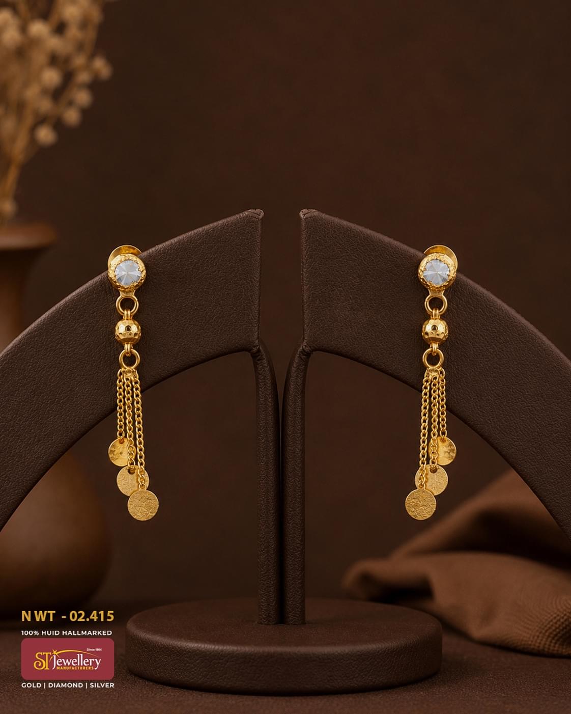 Elegant gold tassel earrings with sparkling white stone studs and dangling coin charms, crafted for festive and party wear.