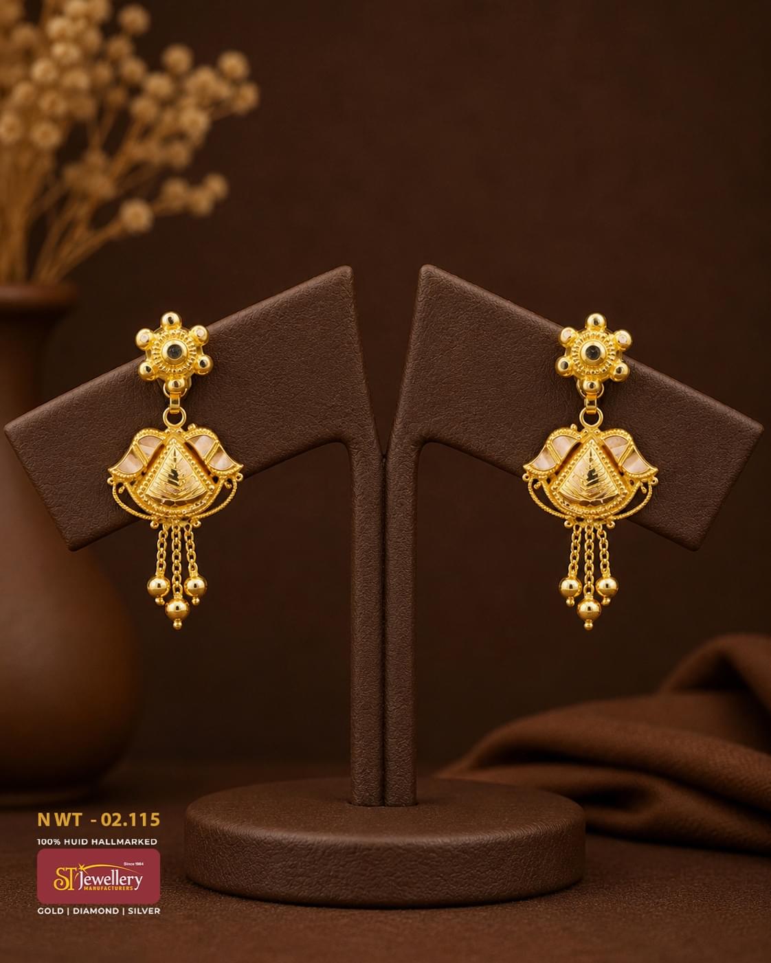 Traditional gold drop earrings with intricate temple-inspired design, white enamel accents, and dangling gold bead tassels for festive and bridal wear.
