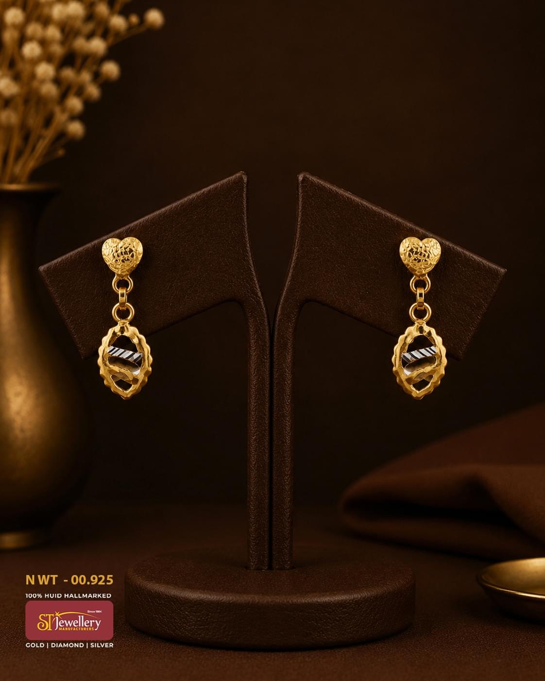 Elegant gold heart stud drop earrings featuring an oval dual-tone textured pendant with modern cutwork design, perfect for daily wear and festive occasions.