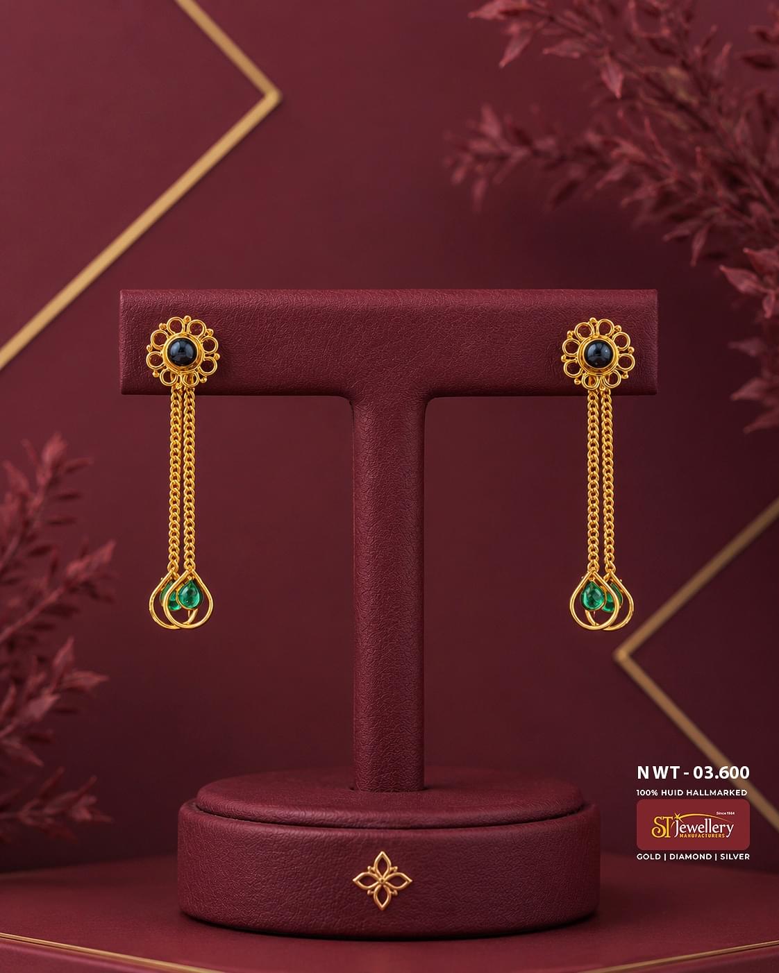 Elegant gold floral chain drop earrings featuring black gemstone stud tops with delicate dual chain tassels and emerald green teardrop accents, perfect for festive and party wear.