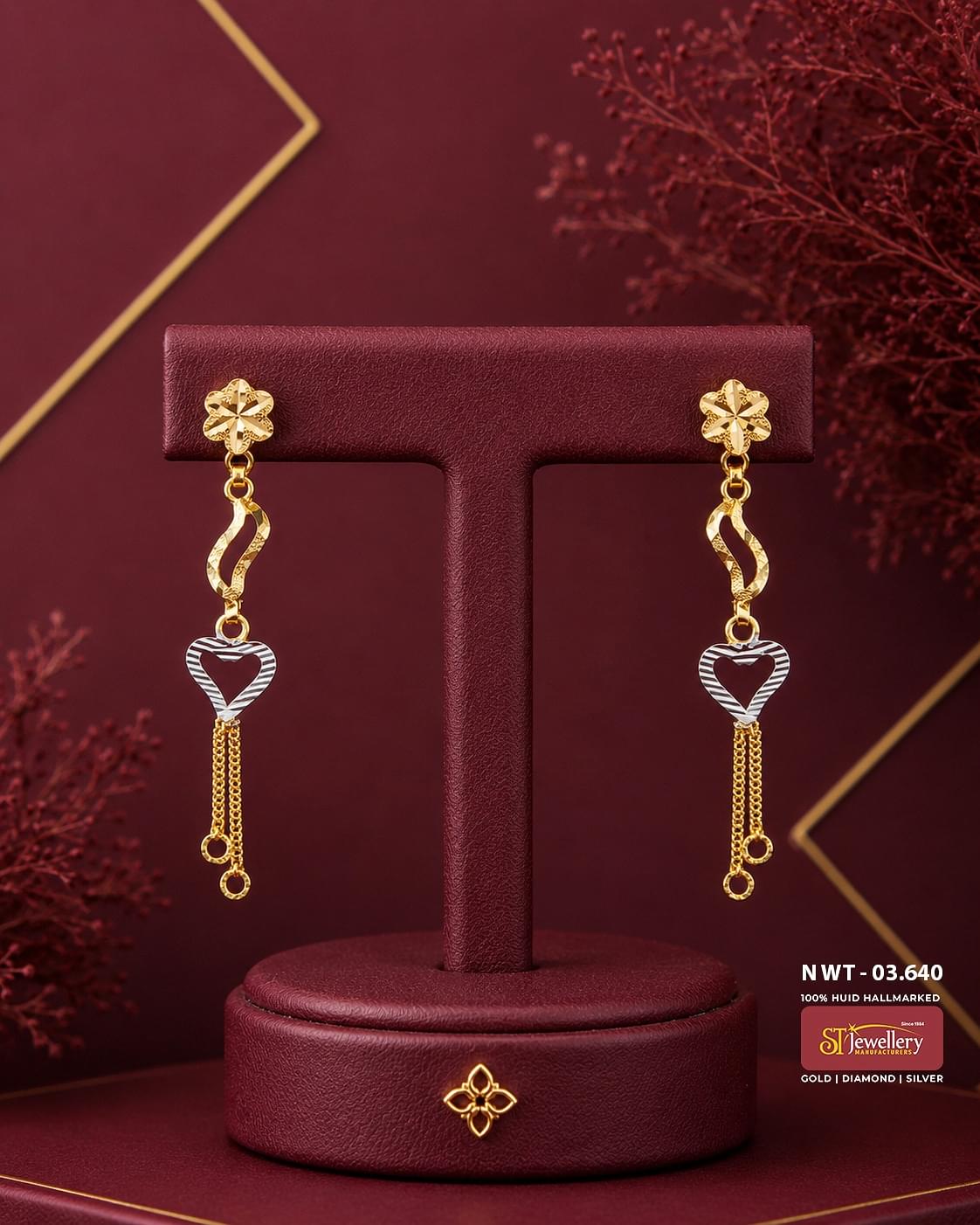 Elegant two-tone gold heart drop earrings featuring floral stud tops, twisted gold links, open heart motifs, and delicate chain tassels, perfect for festive and everyday wear.