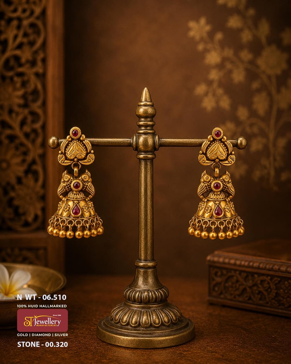 Traditional antique gold jhumka earrings with ruby red stone accents, handcrafted South Indian temple jewellery featuring intricate bird motifs and classic gold bead danglers.