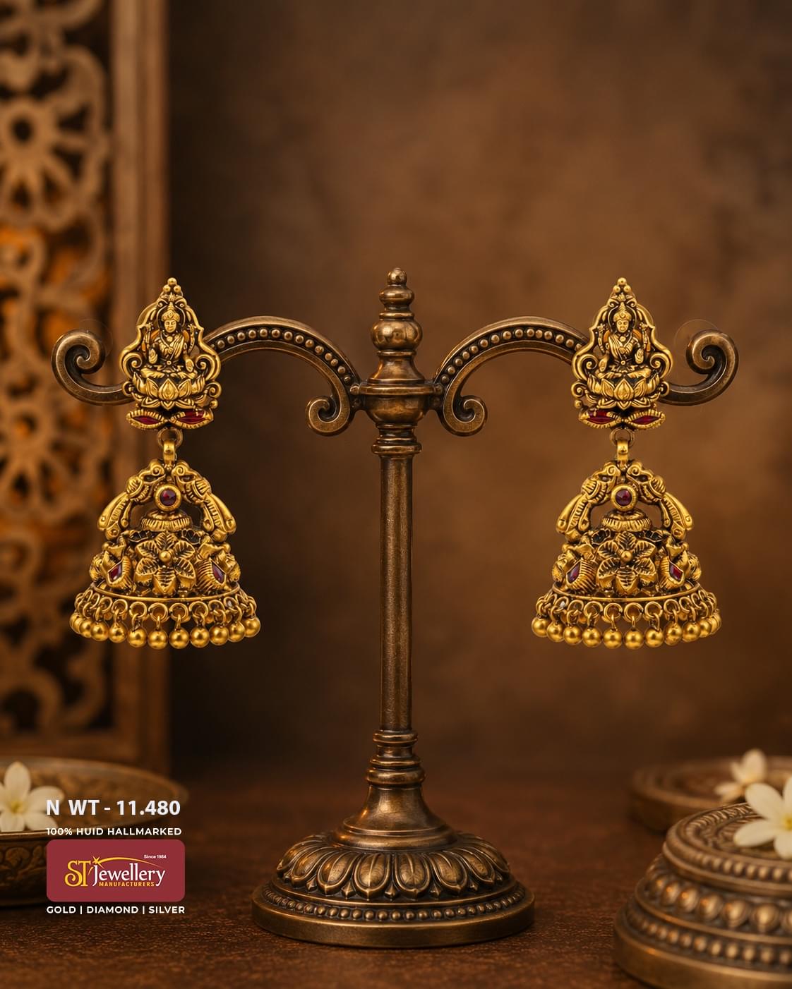 Antique Lakshmi temple gold jhumka earrings featuring Goddess Lakshmi motifs, intricate floral carvings, ruby stone accents, traditional gold bead danglers, and handcrafted South Indian bridal jewellery.