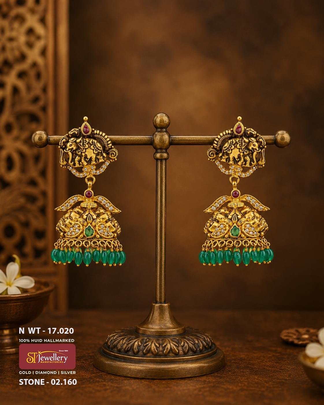 Antique temple gold jhumka earrings featuring elephant motifs, emerald green bead danglers, ruby and CZ stone accents, handcrafted South Indian bridal temple jewellery.