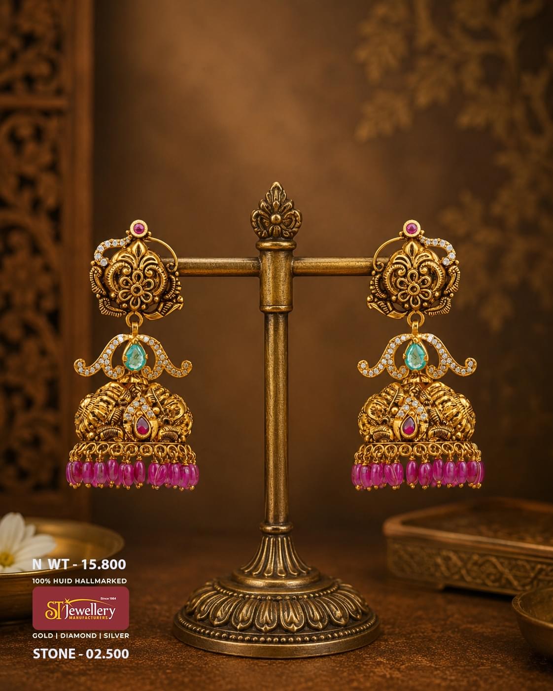 Antique temple gold jhumka earrings featuring floral motifs, aqua green stones, ruby accents, CZ diamond detailing, and pink bead danglers in traditional South Indian bridal jewellery.