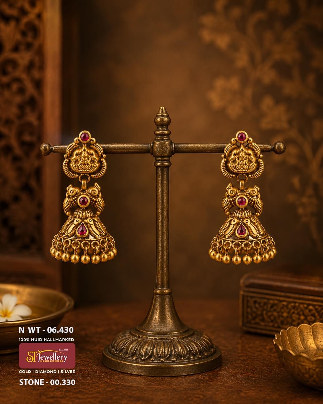 Antique temple gold jhumka earrings featuring Goddess Lakshmi motifs, ruby red stones, traditional owl-inspired detailing, and handcrafted South Indian bridal temple jewellery.
