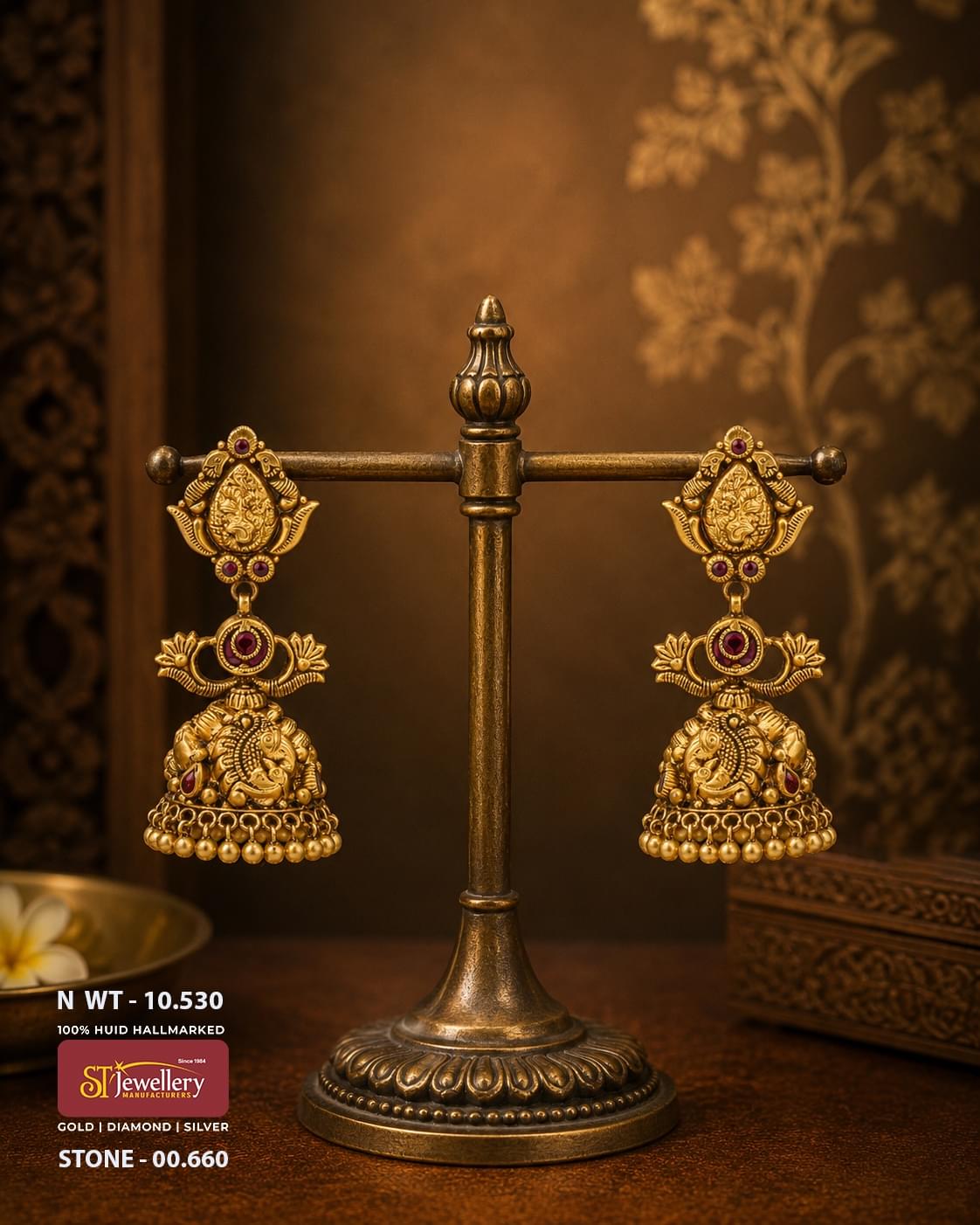 Antique temple gold Ganesha jhumka earrings featuring Lord Ganesha motifs, ruby red stone accents, handcrafted South Indian bridal temple jewellery with gold bead danglers.
