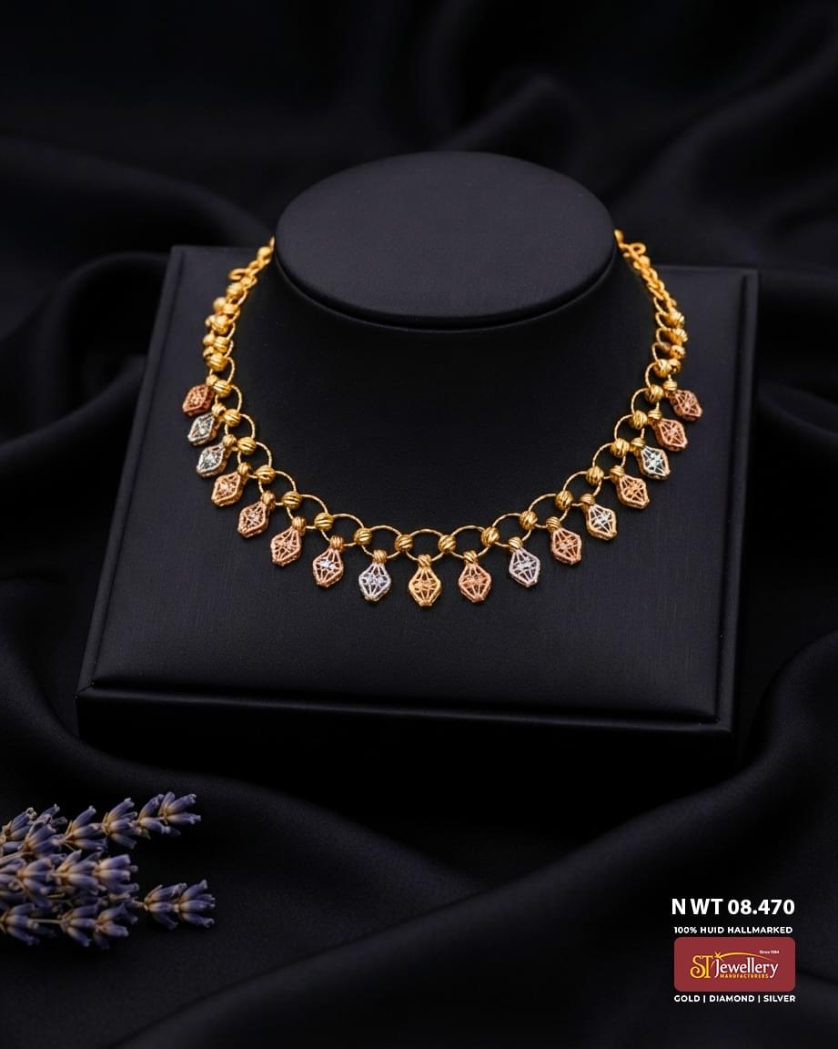 Lightweight tri-colour gold necklace with circular link design and rose gold and white gold dangling motifs for women.