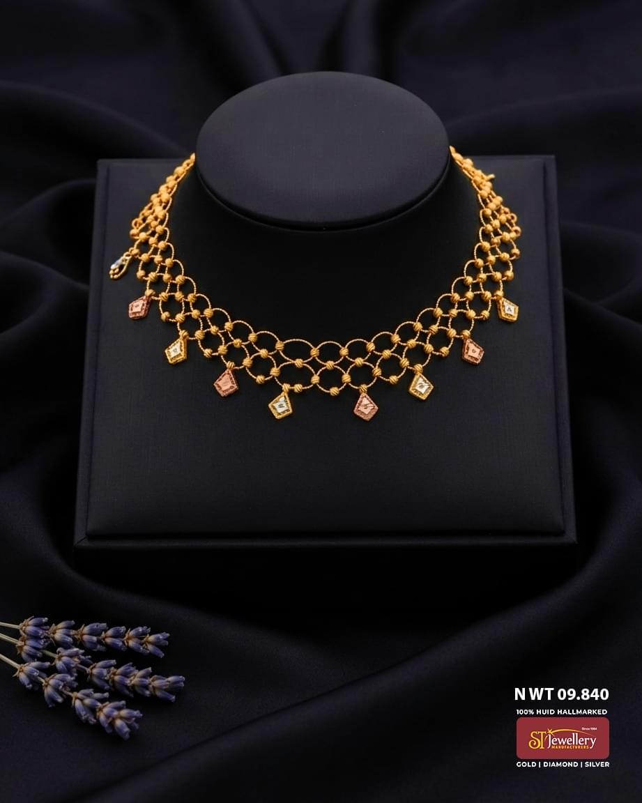 Lightweight gold necklace with intricate interlinked pattern and rose gold and white gold diamond-shaped dangling motifs for women.
