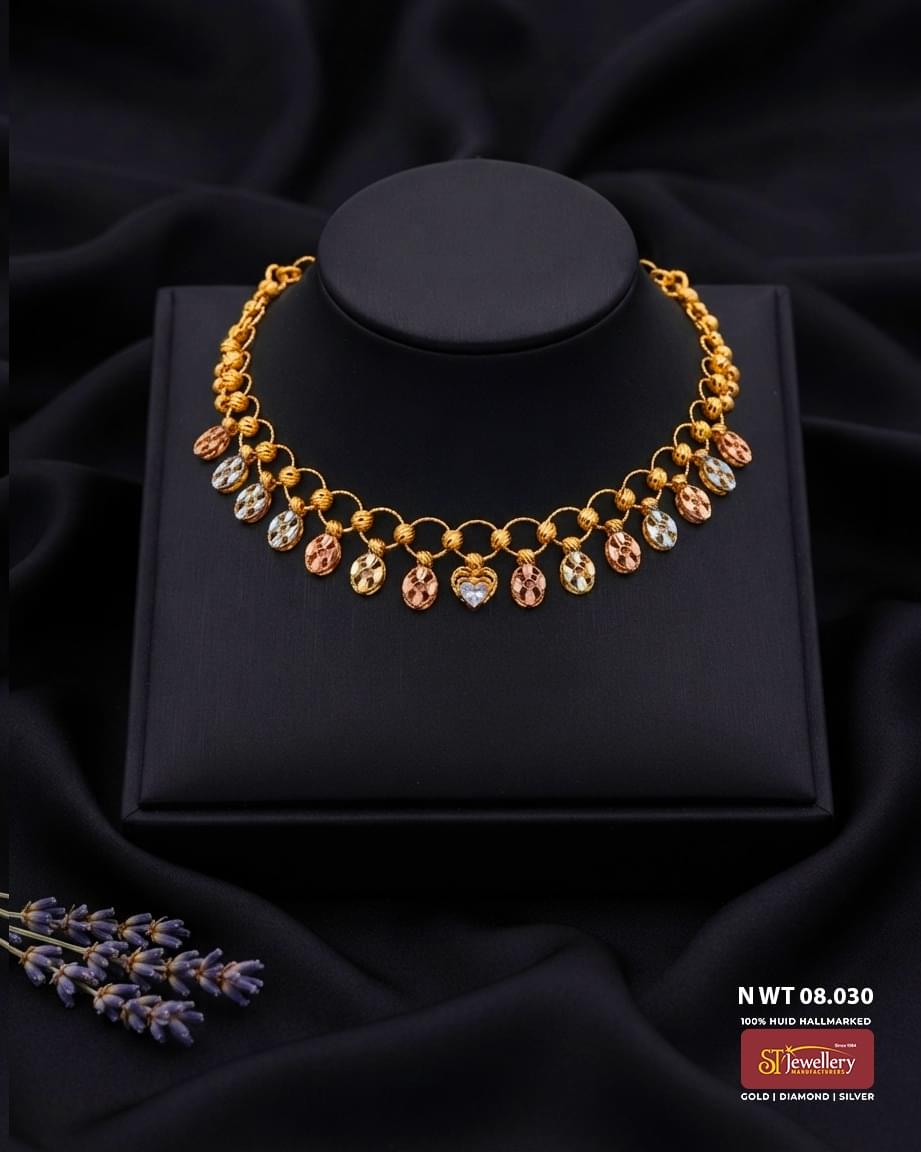 Lightweight tri-colour gold necklace with circular link design, oval dangling motifs and heart-shaped centre detail for women.