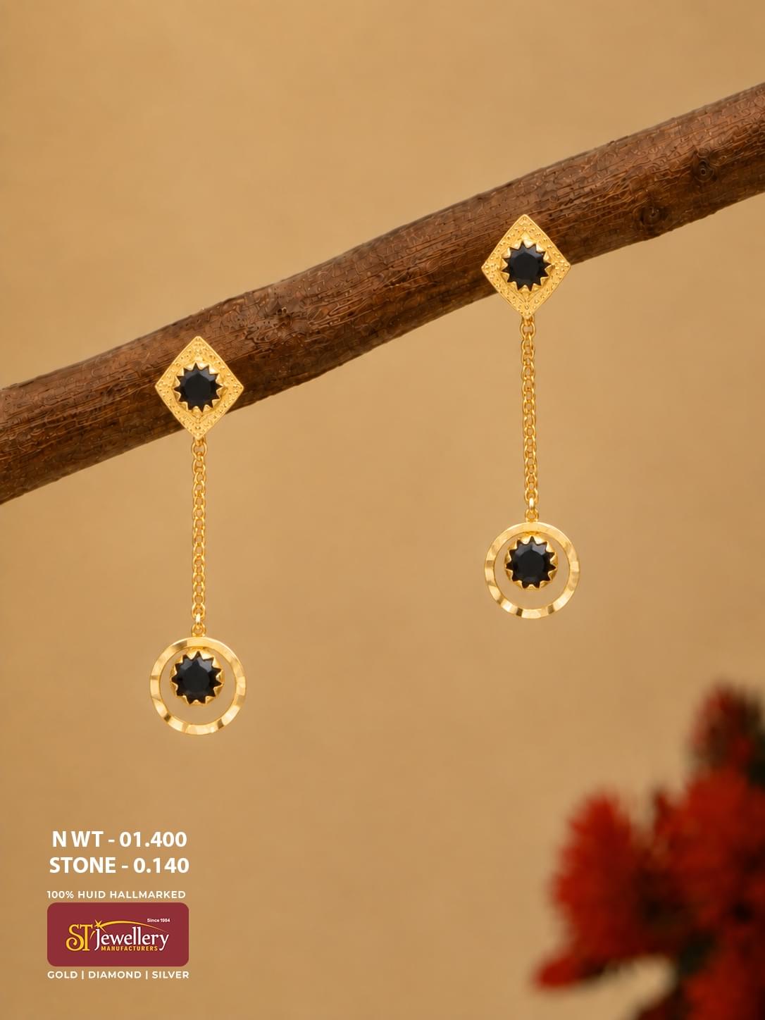 Lightweight gold chain drop earrings with black stones, diamond-shaped stud tops and circular hanging motifs.