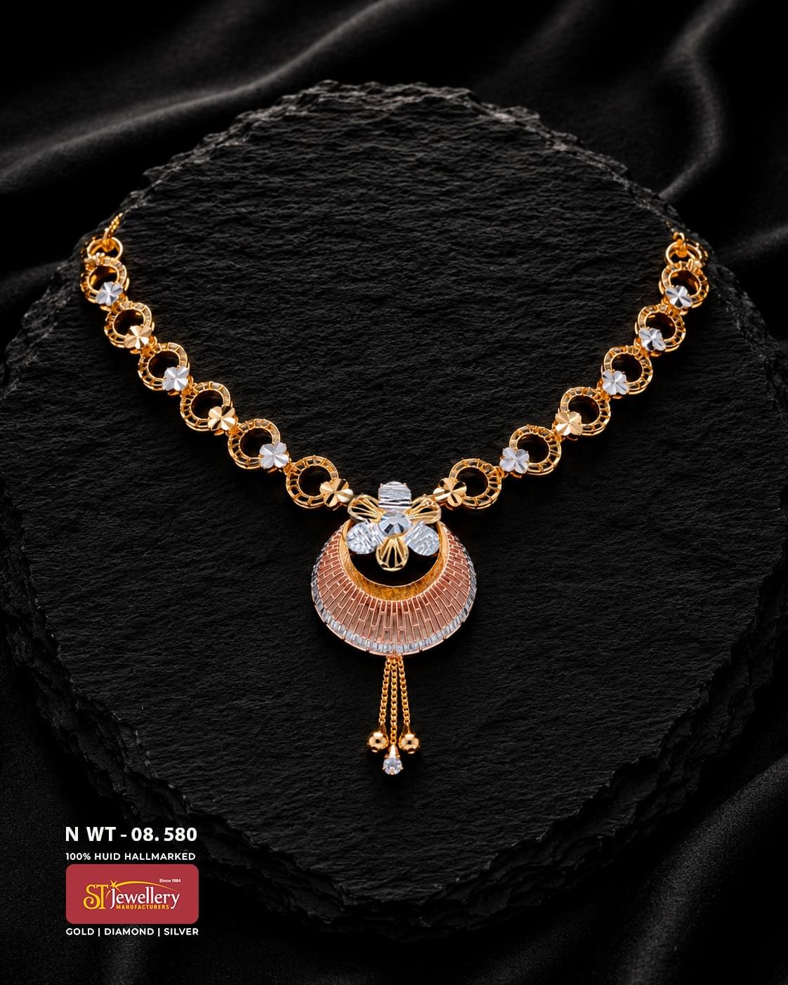 Multitone gold necklace with circular openwork links, small floral accents and a decorative rose, yellow and white-gold pendant finished with three delicate hanging drops.