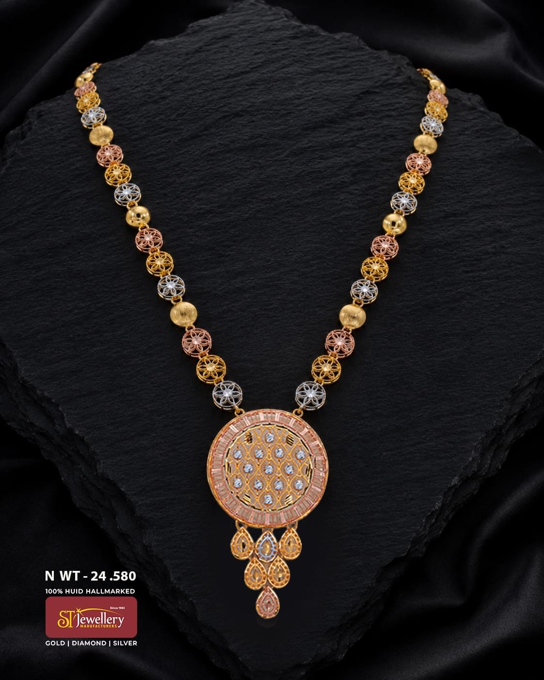 Elegant multitone gold necklace featuring intricate round filigree motifs in yellow, rose and white tones, finished with a large circular pendant and delicate teardrop-shaped dangling details.