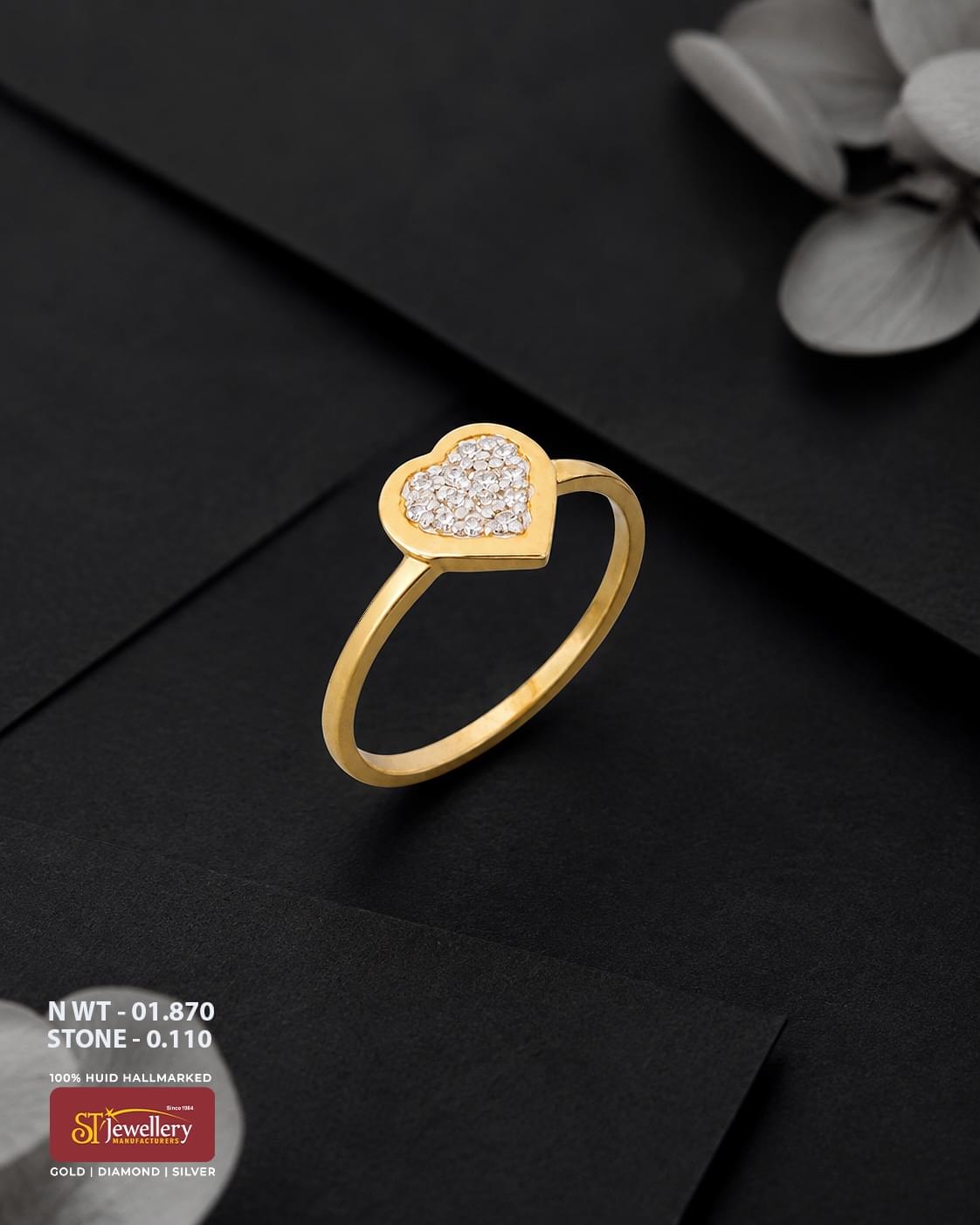 916 HUID hallmarked yellow gold ring featuring a heart-shaped design filled with sparkling white stones, displayed on a premium black background.