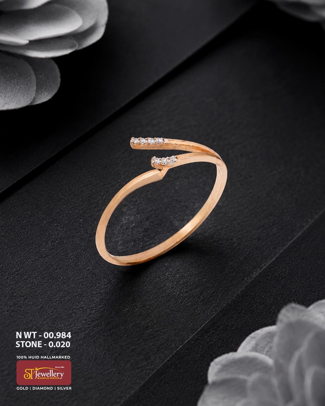 Minimal rose gold ring featuring a modern open-ended crossover design with delicate white stone accents, displayed on a premium black background.
