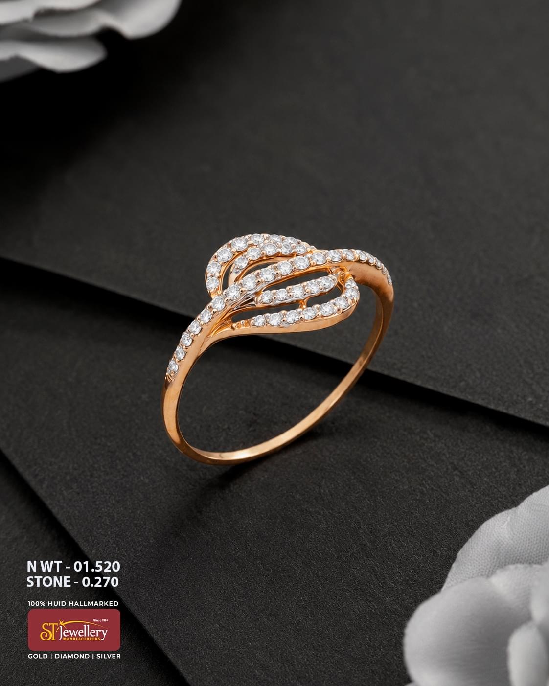 Elegant rose gold ring featuring an intricate layered leaf-inspired design embellished with sparkling white stones, displayed on a premium matte black background.