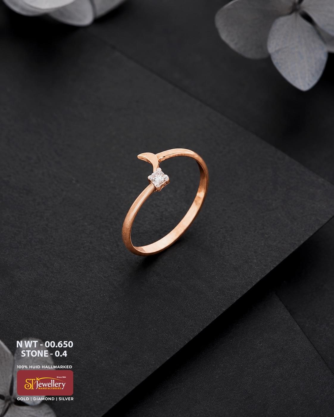 Minimal rose gold ring featuring a delicate open-ended design with a single sparkling white stone, displayed on a premium matte black background.