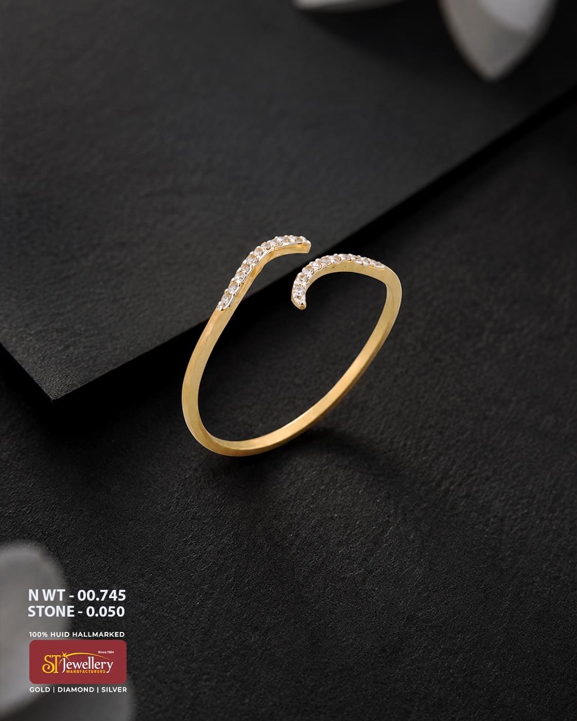 Minimal gold ring featuring a modern open-ended curved design with delicate white stone accents, displayed on a premium matte black background.