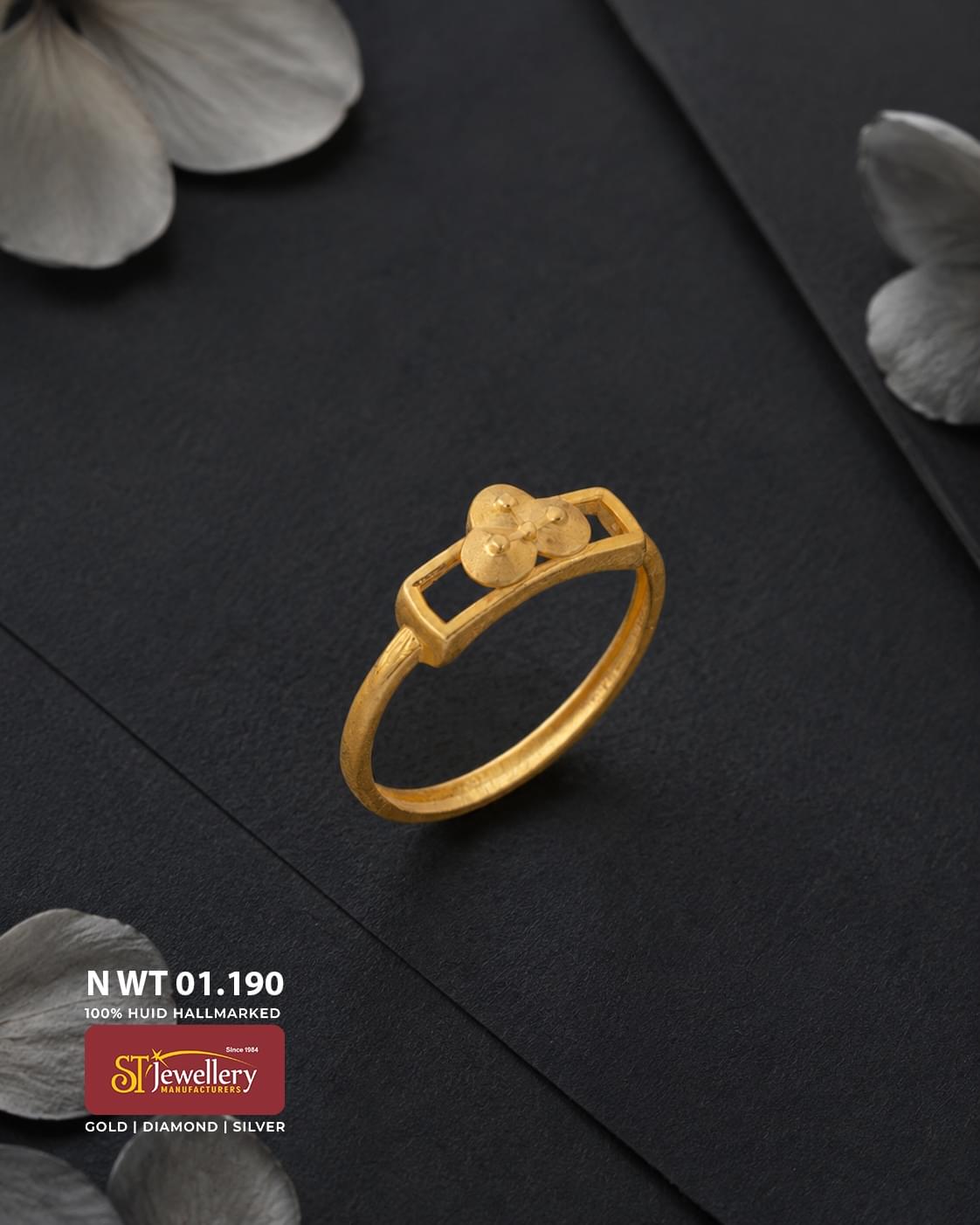 Elegant lightweight gold ring featuring a geometric openwork top with a delicate three-disc floral motif, displayed on a matte black background.