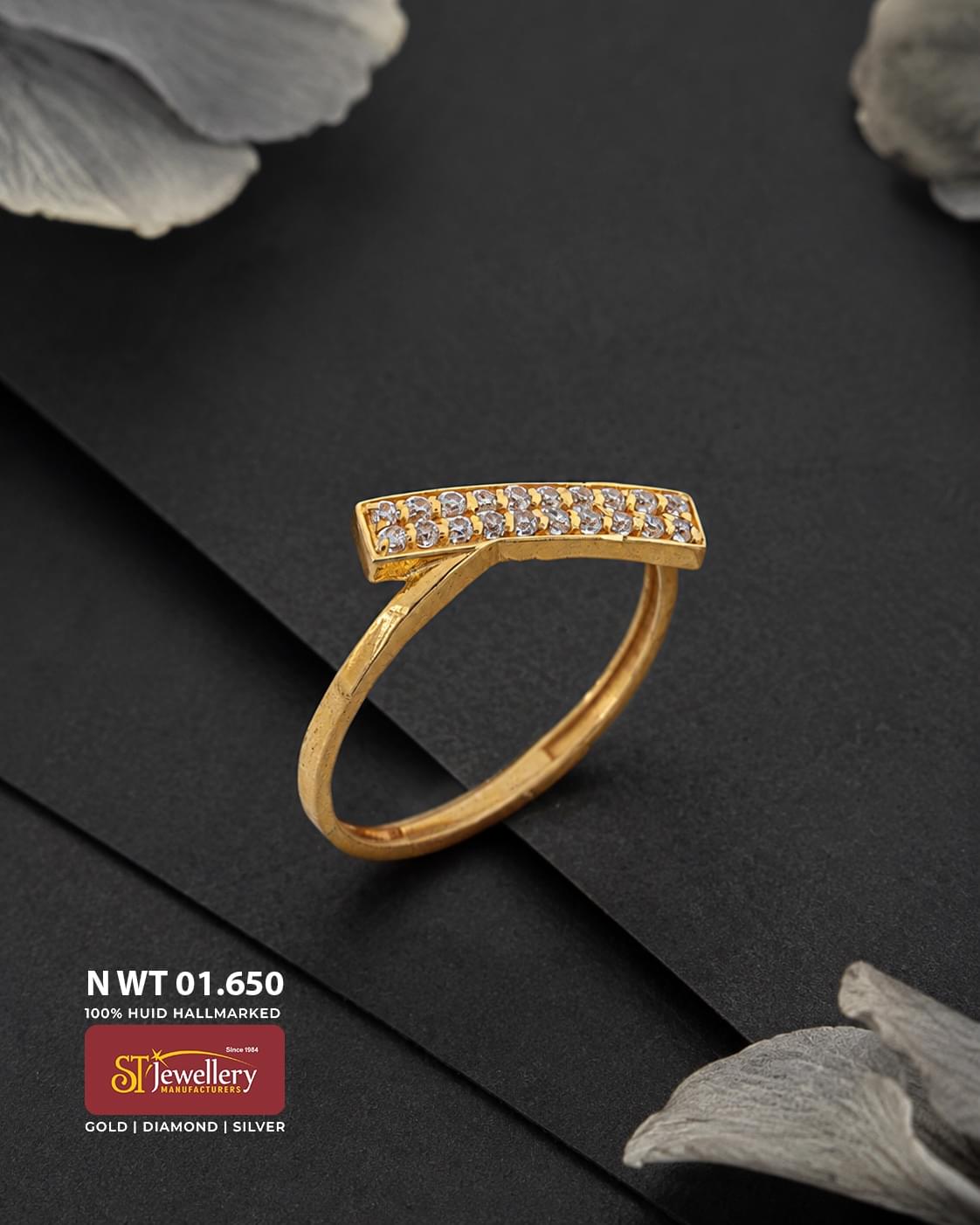 Elegant gold ring featuring a curved rectangular top set with two rows of sparkling clear stones, displayed on a premium matte black background.
