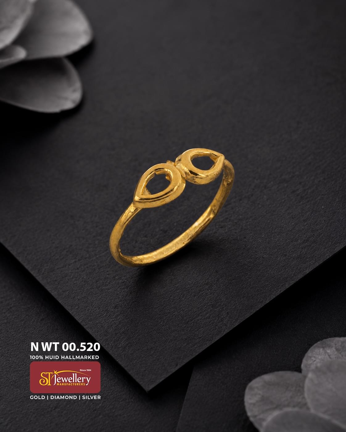 Lightweight gold ring featuring a minimal double teardrop openwork design, displayed on a premium matte black background.