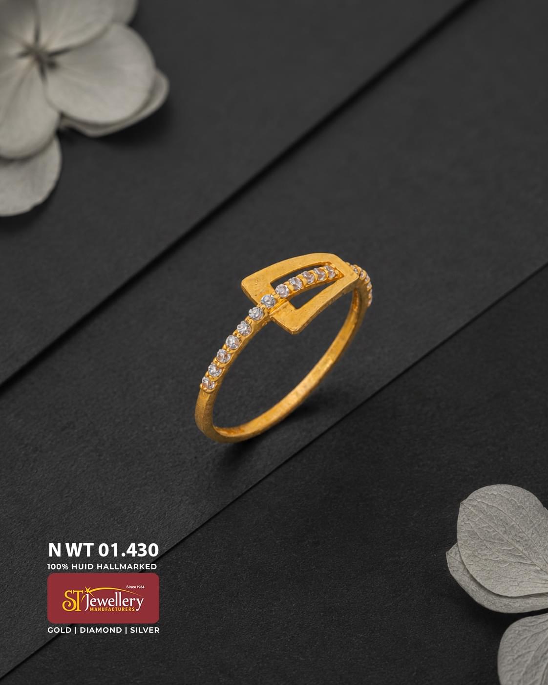 Elegant gold ring with a modern geometric open-frame design and sparkling clear stone accents along the band and centre.