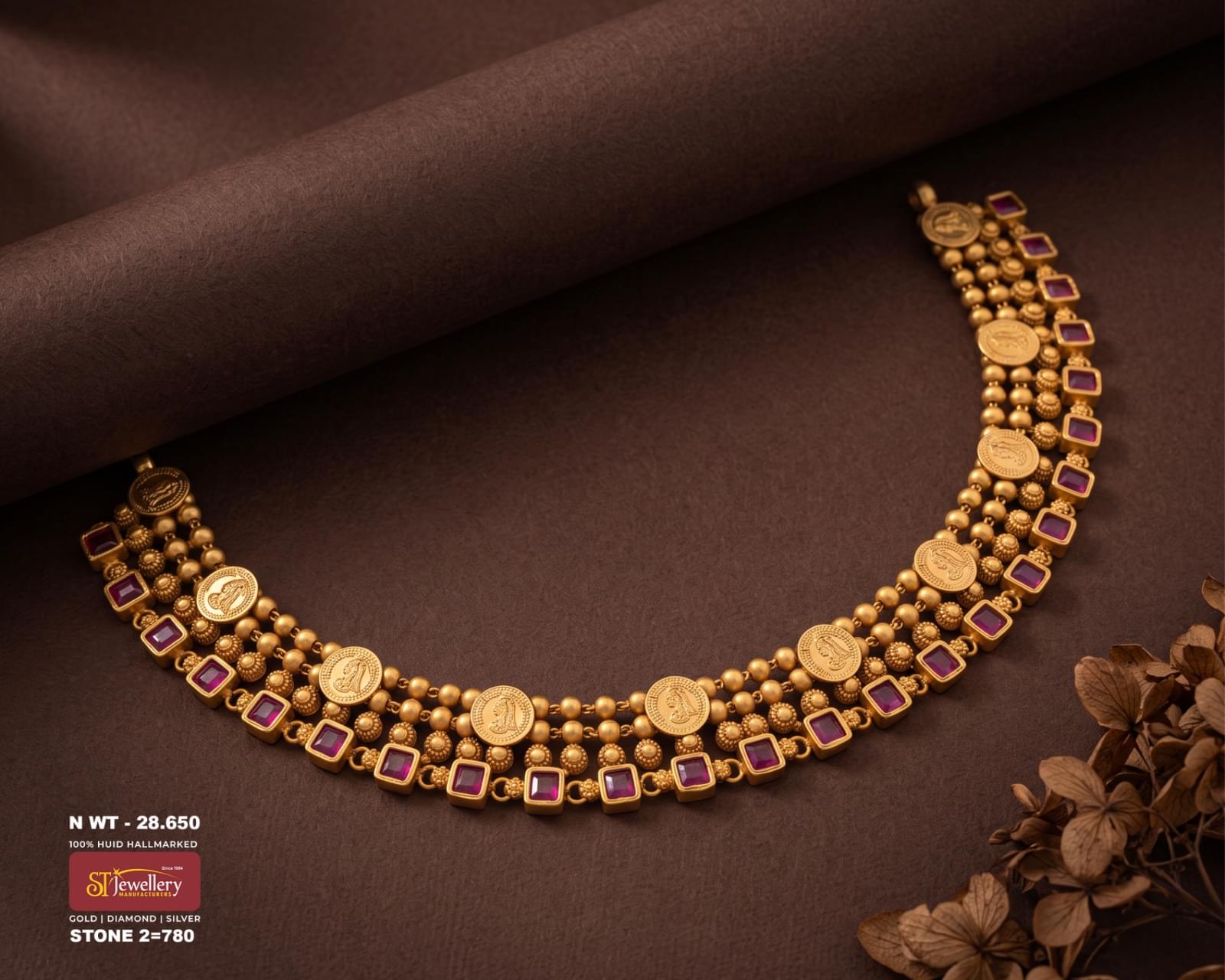 Traditional antique gold necklace with layered gold beads, engraved coin motifs and square red stone accents.